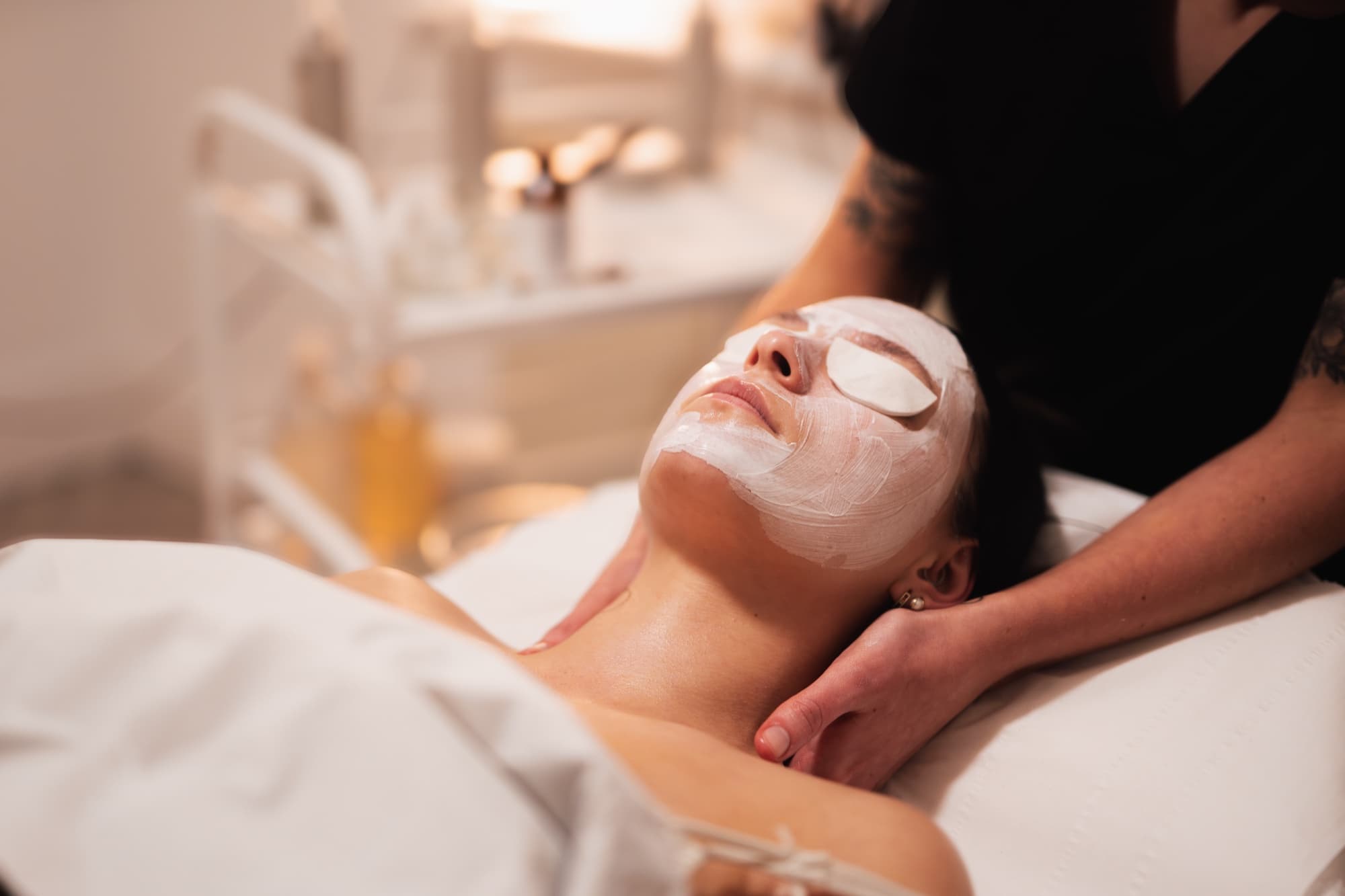 Client lying back with a brightening mask on during a Fresh Glow Facial at Fresh Faced.