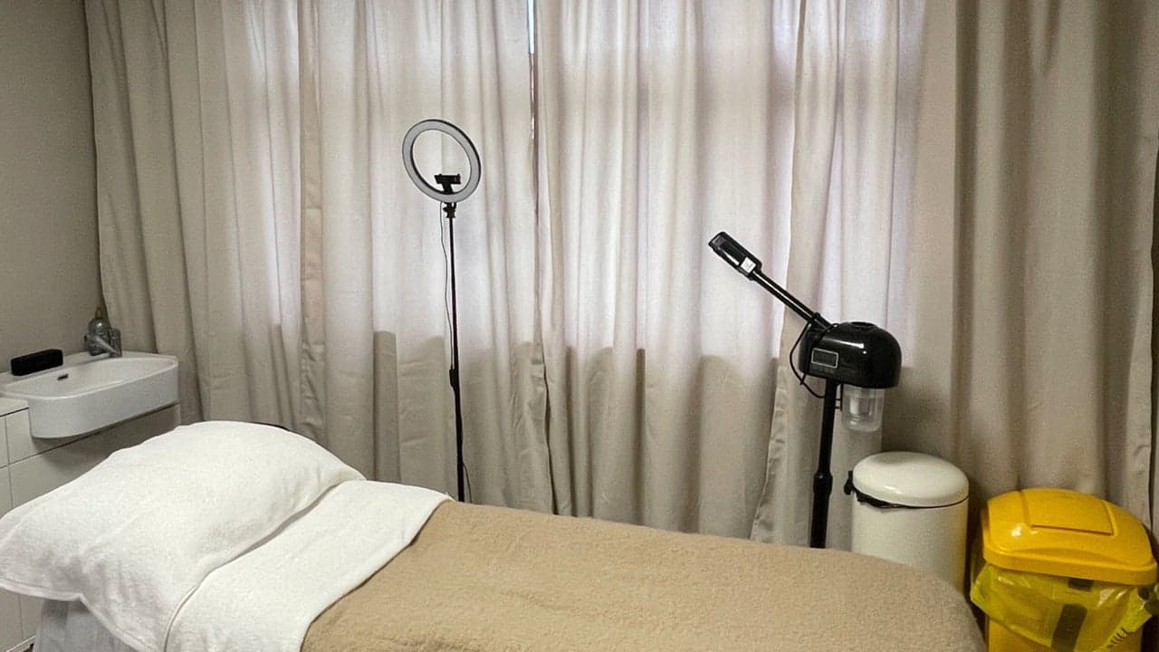 The treatment room at Fresh Faced Skin Clinic in Scartho, Grimsby, with a draped facial bed and warm lighting.